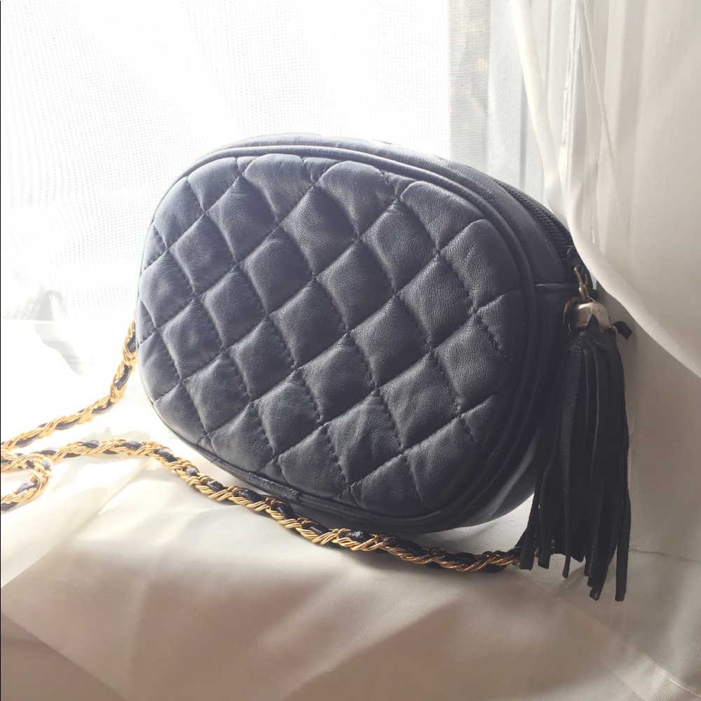 Small black quilted purse with gold chain, tassel